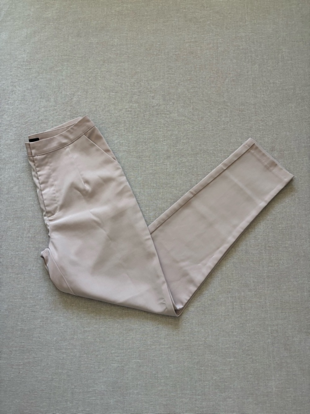 WOMAN pale pink satin trousers.